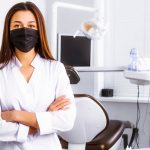 Dentist in her office wearing mask - Top Dental PPO Negotiator - PPO Negotiation and Optimization