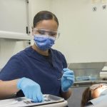 dental hygienist with patient - increase dental team engagement with ongoing dental office training - strategic practice solutions